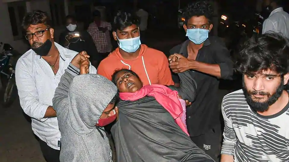 A woman showing symptoms of epilepsy being taken to a hospital in Eluru town of Andhra Pradesh Sunday night. (PTI)
 
 
 
 
 
